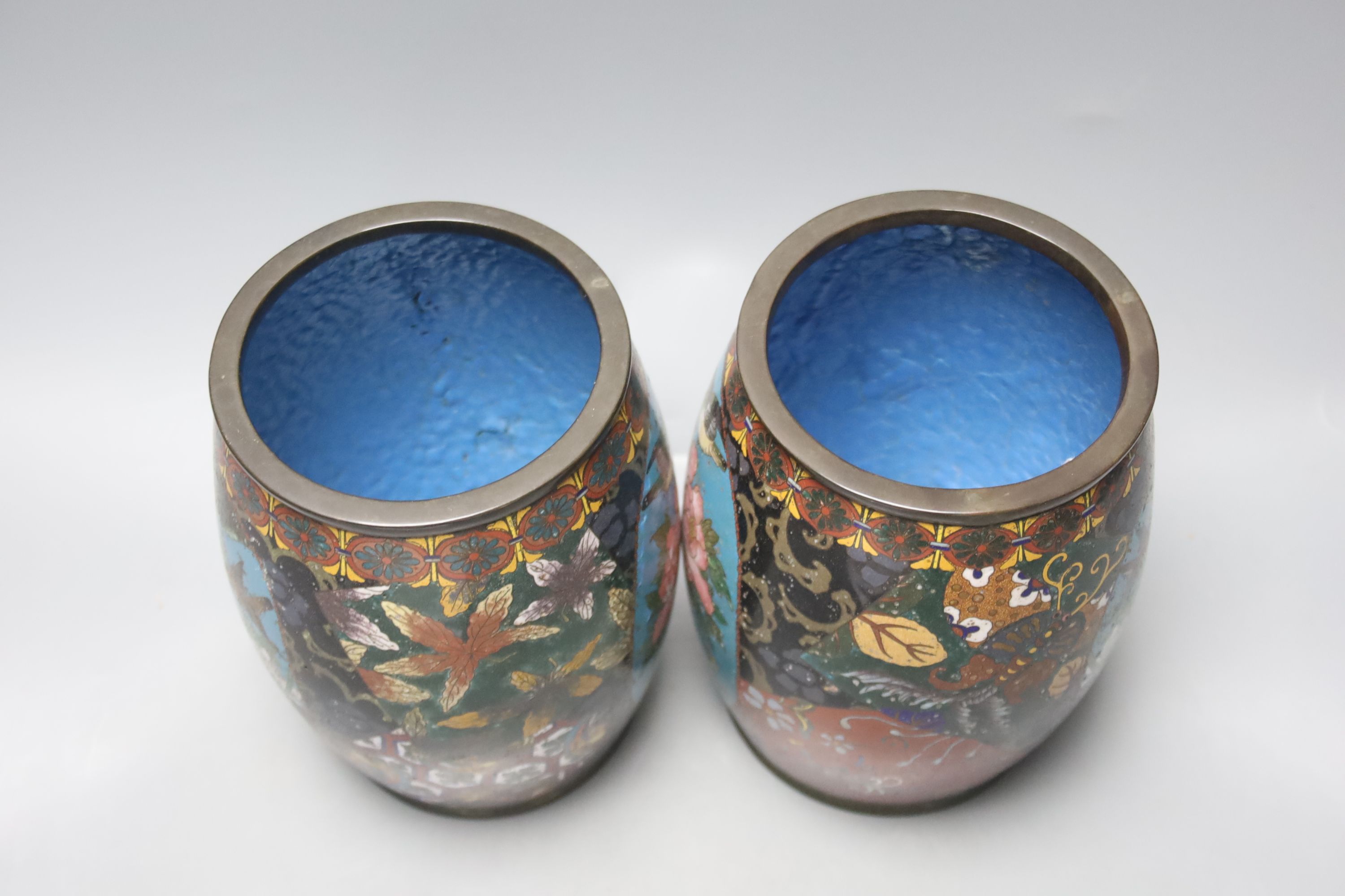 A pair of Japanese cloisonne enamel barrel-shaped vases and a similar bottle vase